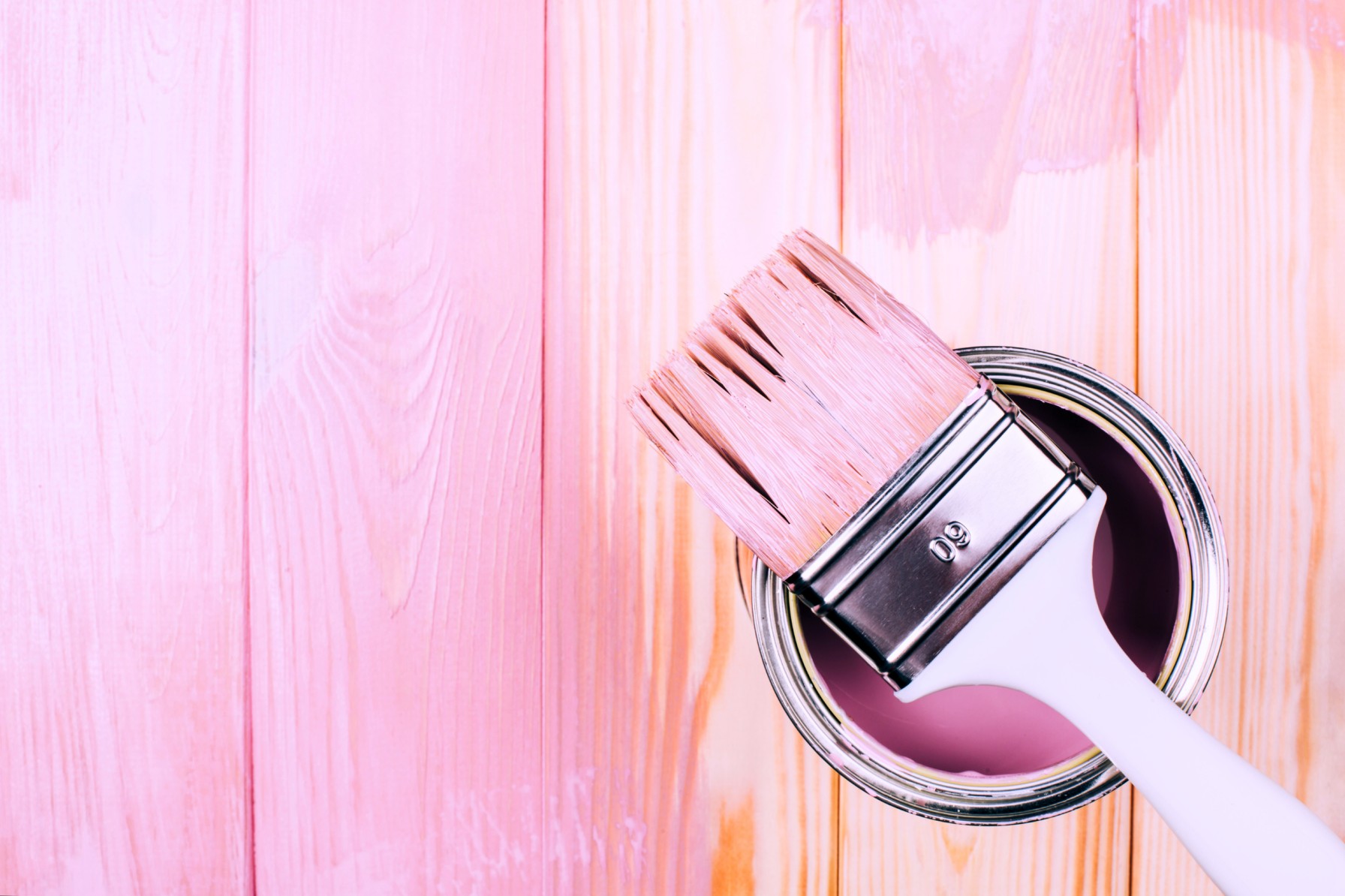 White Brush on Open Can of Pink Color on Painting Wooden Board.