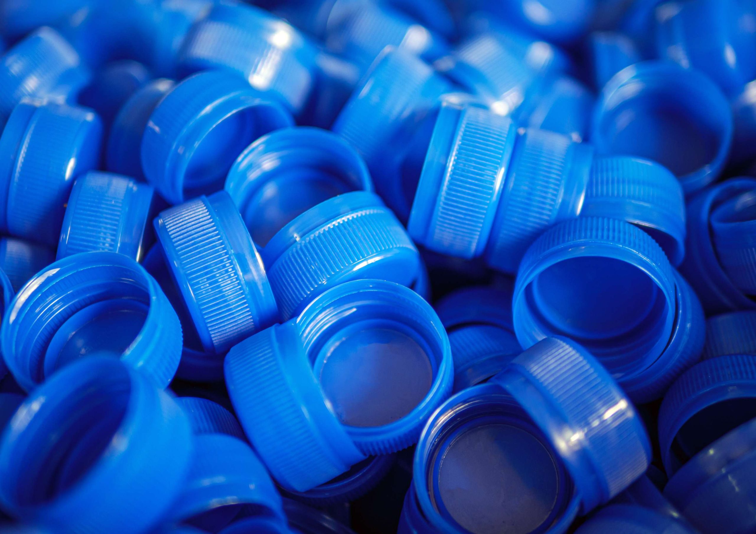 Close-up of blue plastic bottle caps.