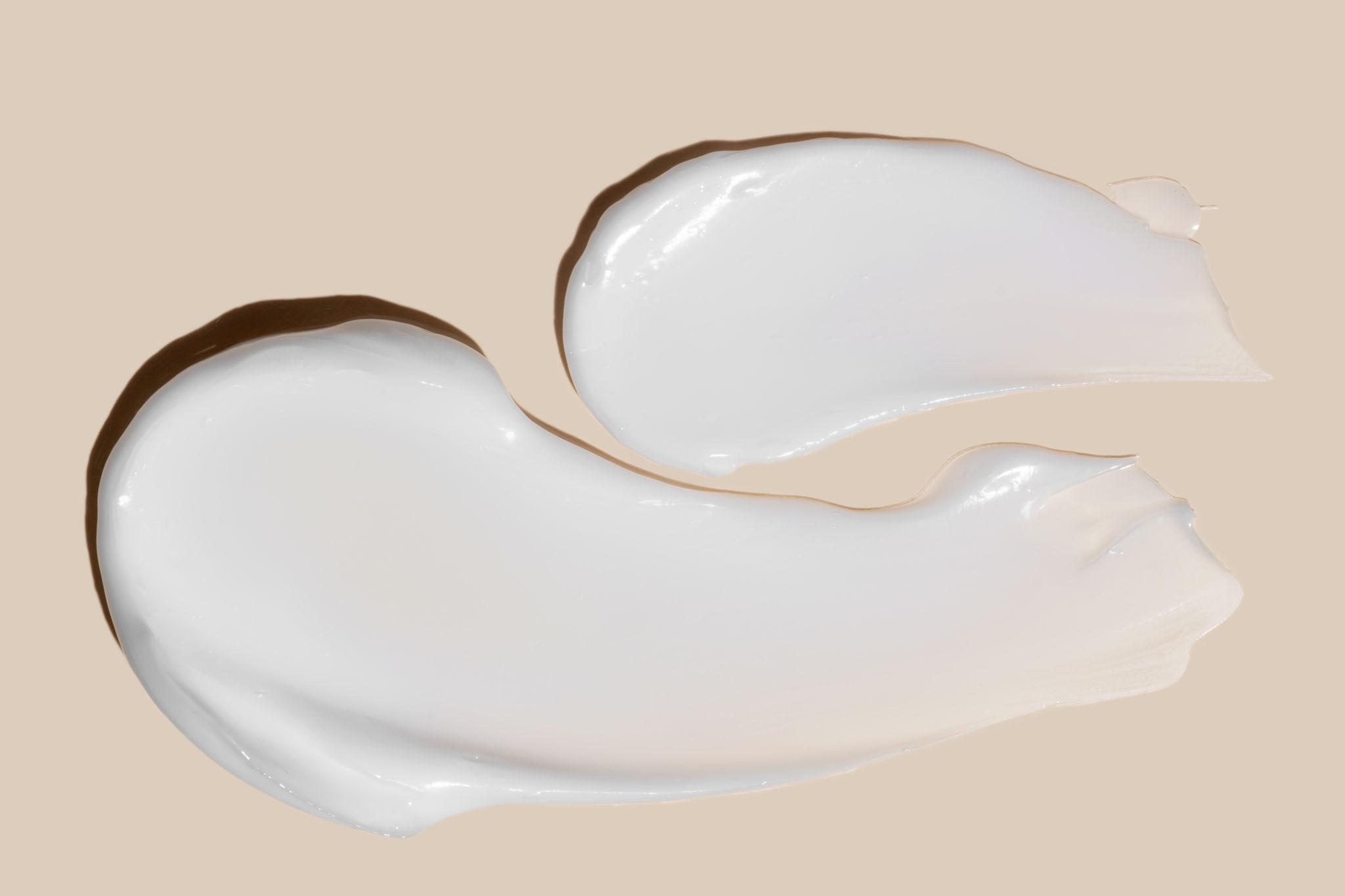 smear on hand cream with fumed silica on a pink background