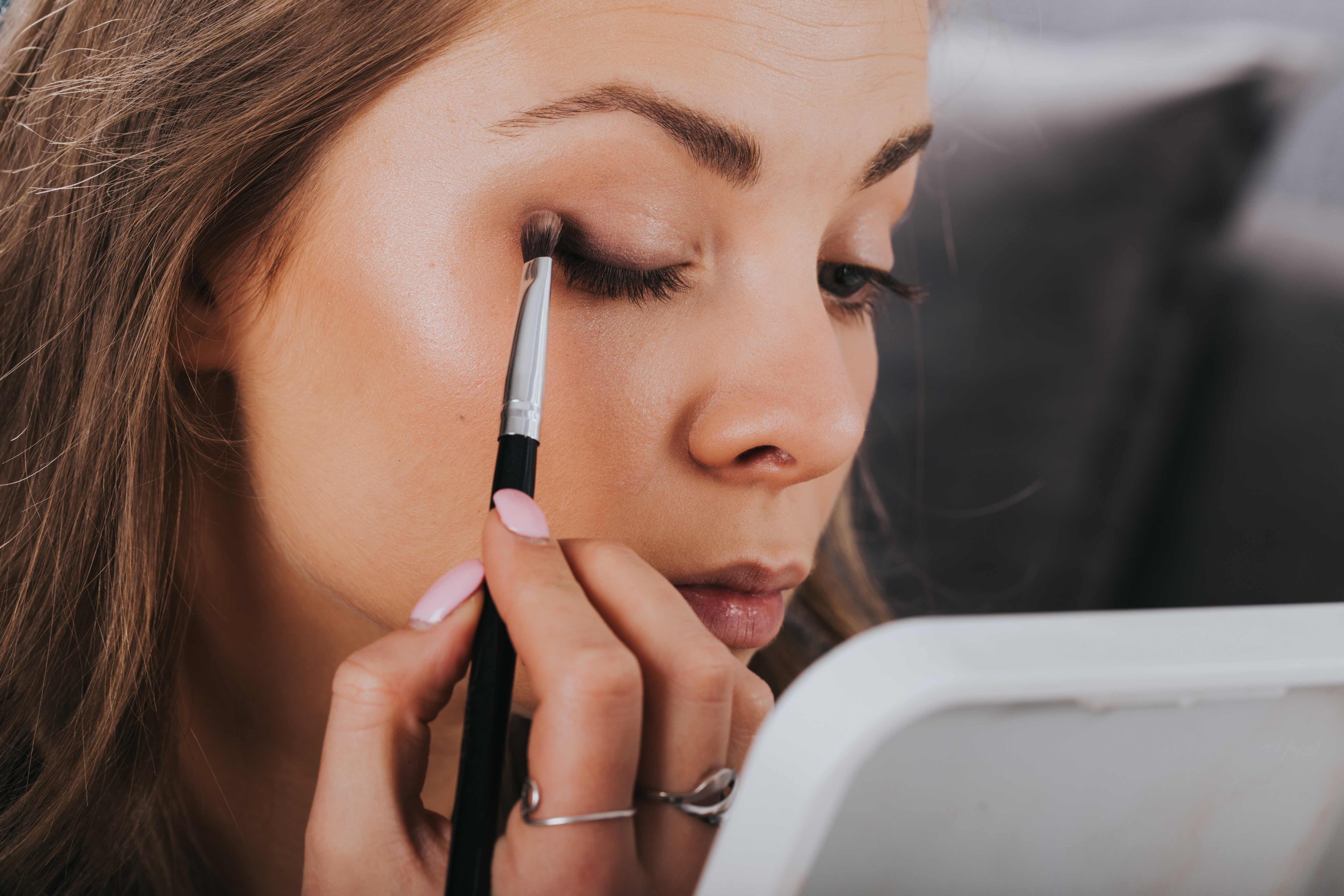 woman applying eye shadow