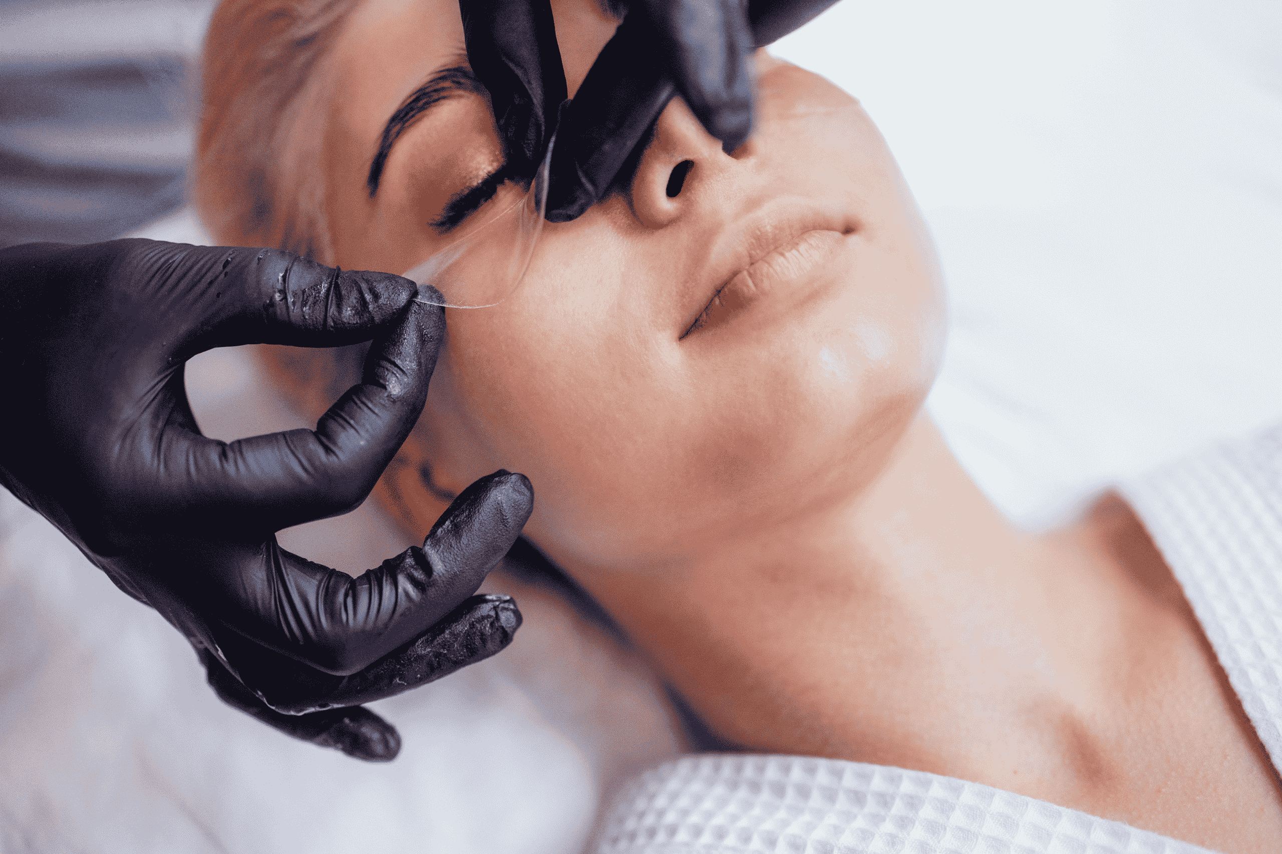 women getting silicone applied to avoid bags around her eyes