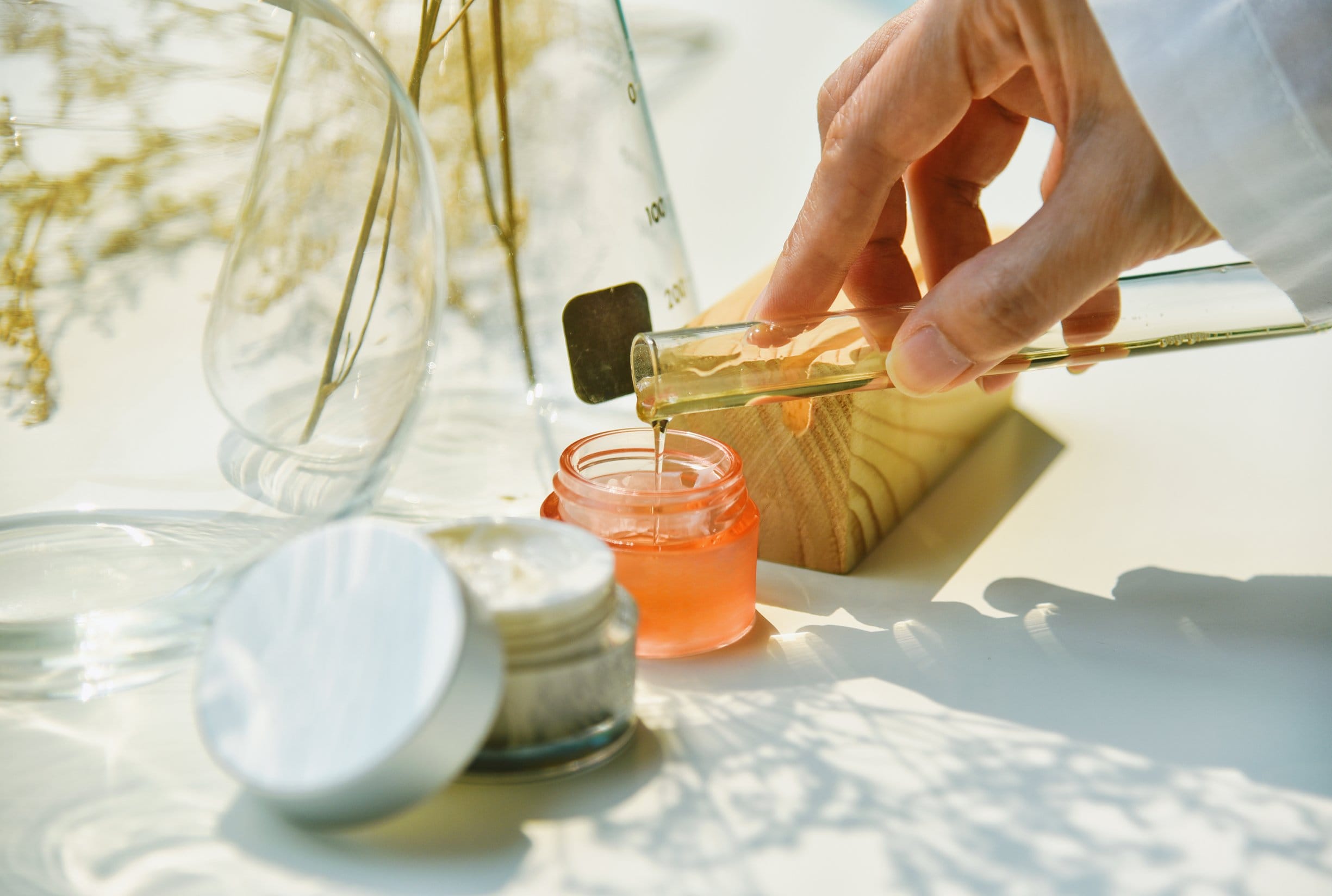 Scientist mixing natural skin care beauty products.