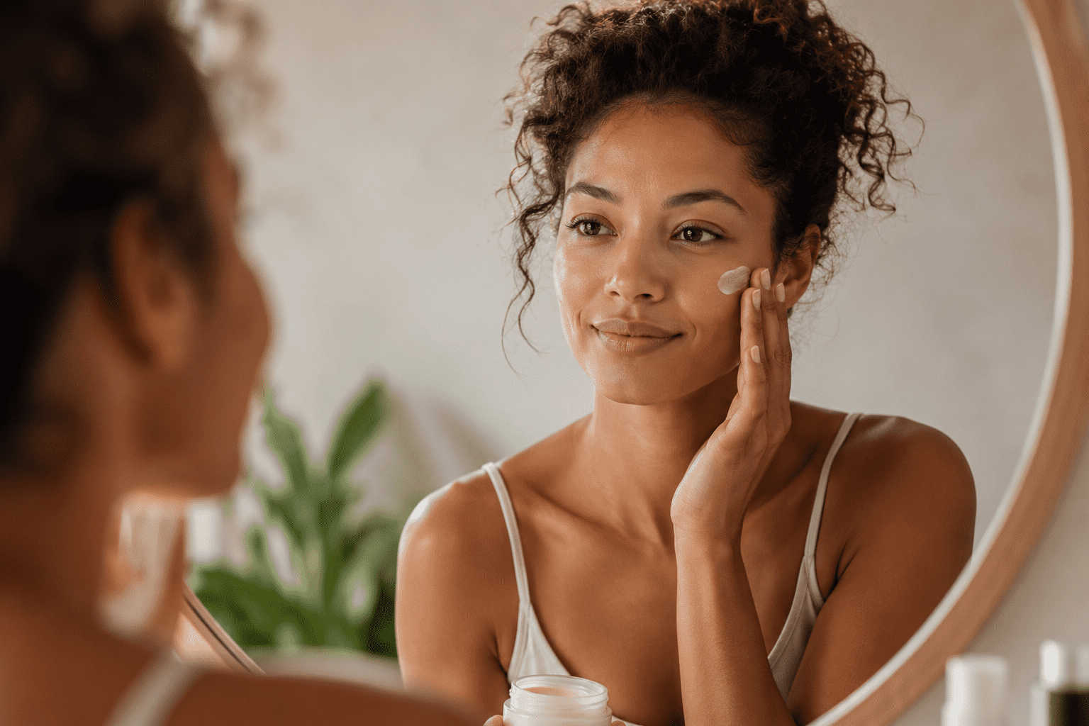 woman putting face cream on