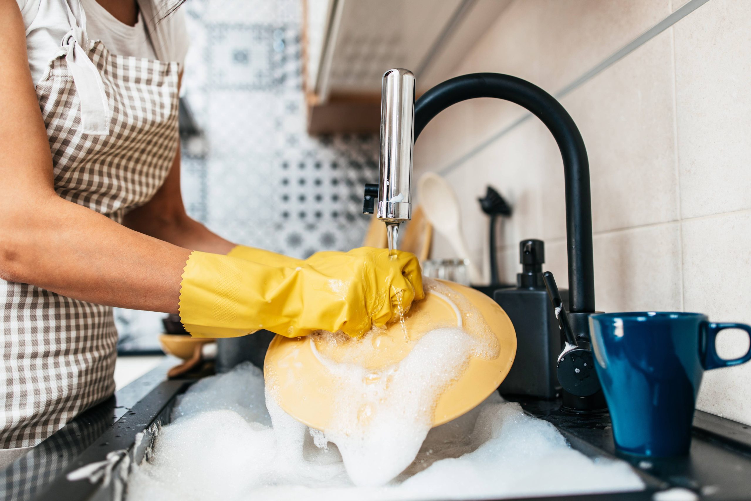 Woman washing the dishes.