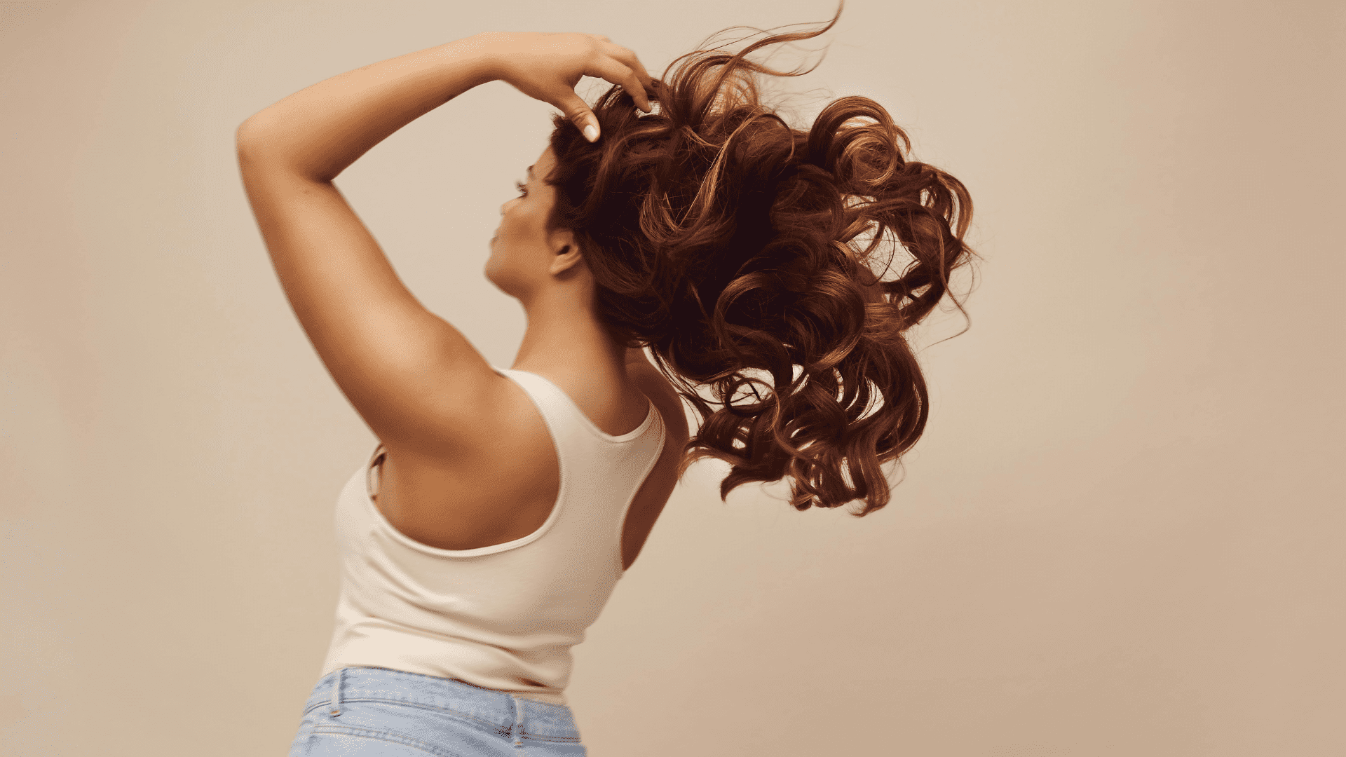 woman brushing her hair with her hands