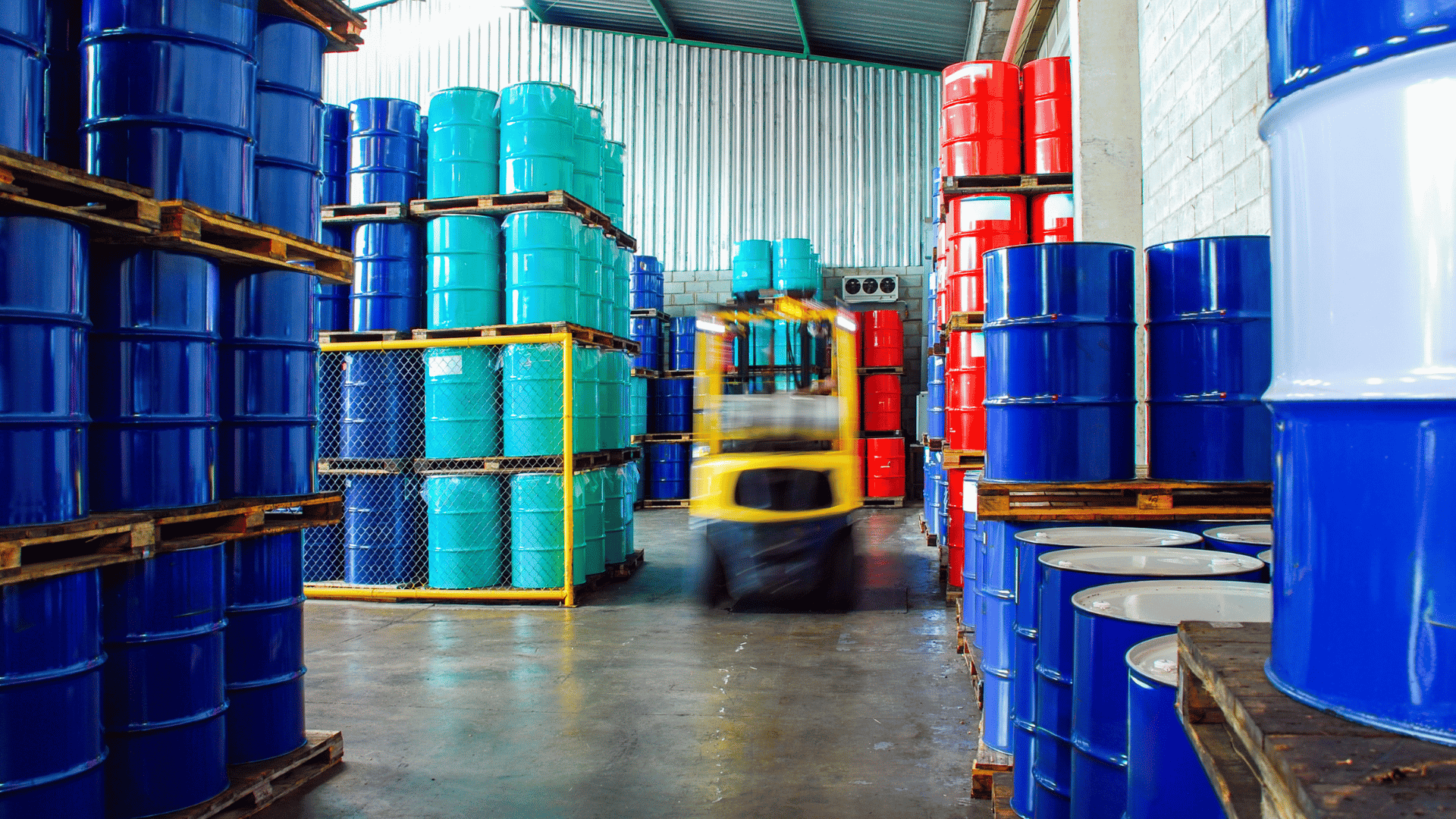 Blue chemical drums in industrial storage, illustrating supply chain risk for restricted substances