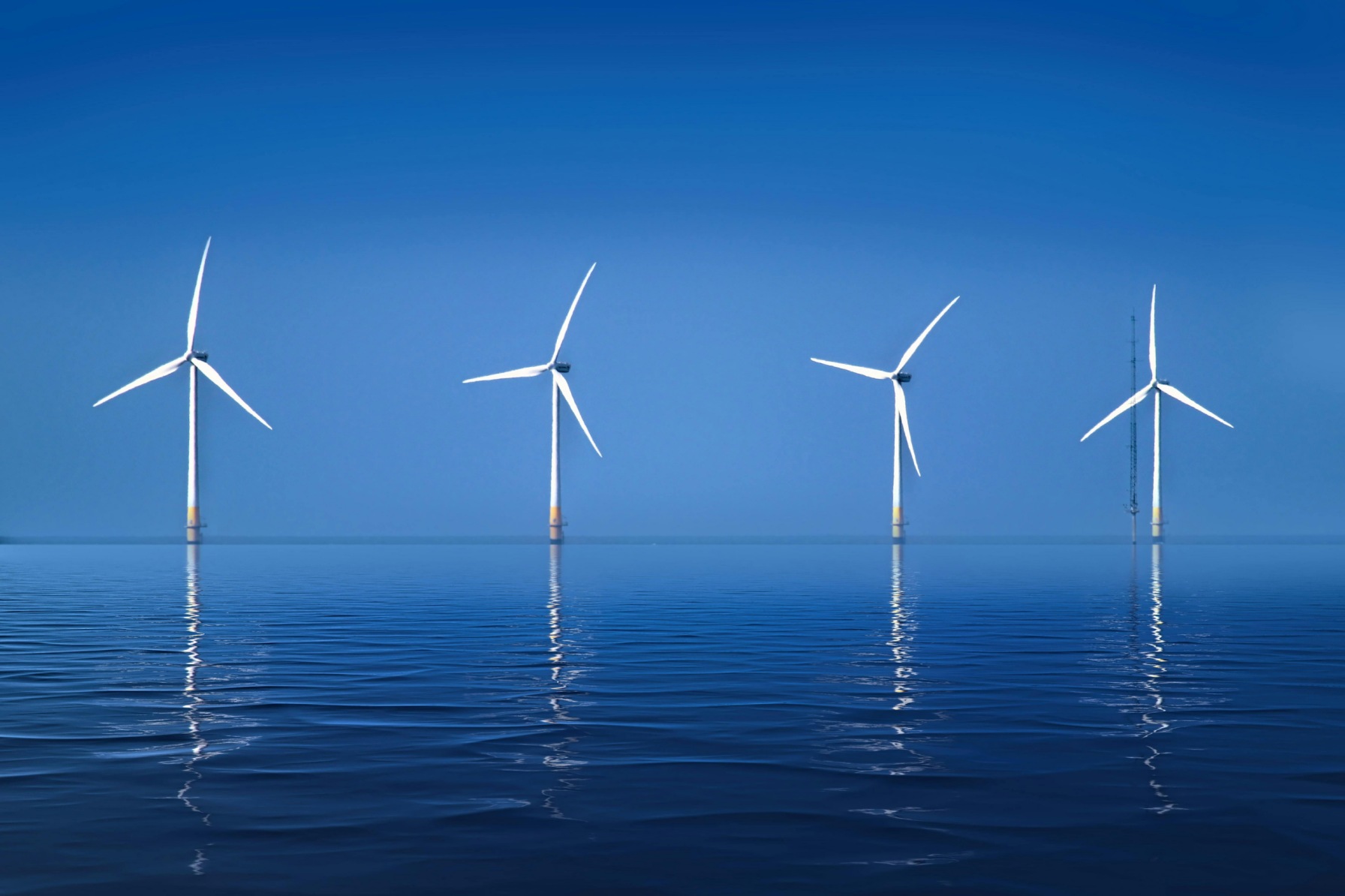 Offshore Wind Turbines Against Clear Blue Sky;