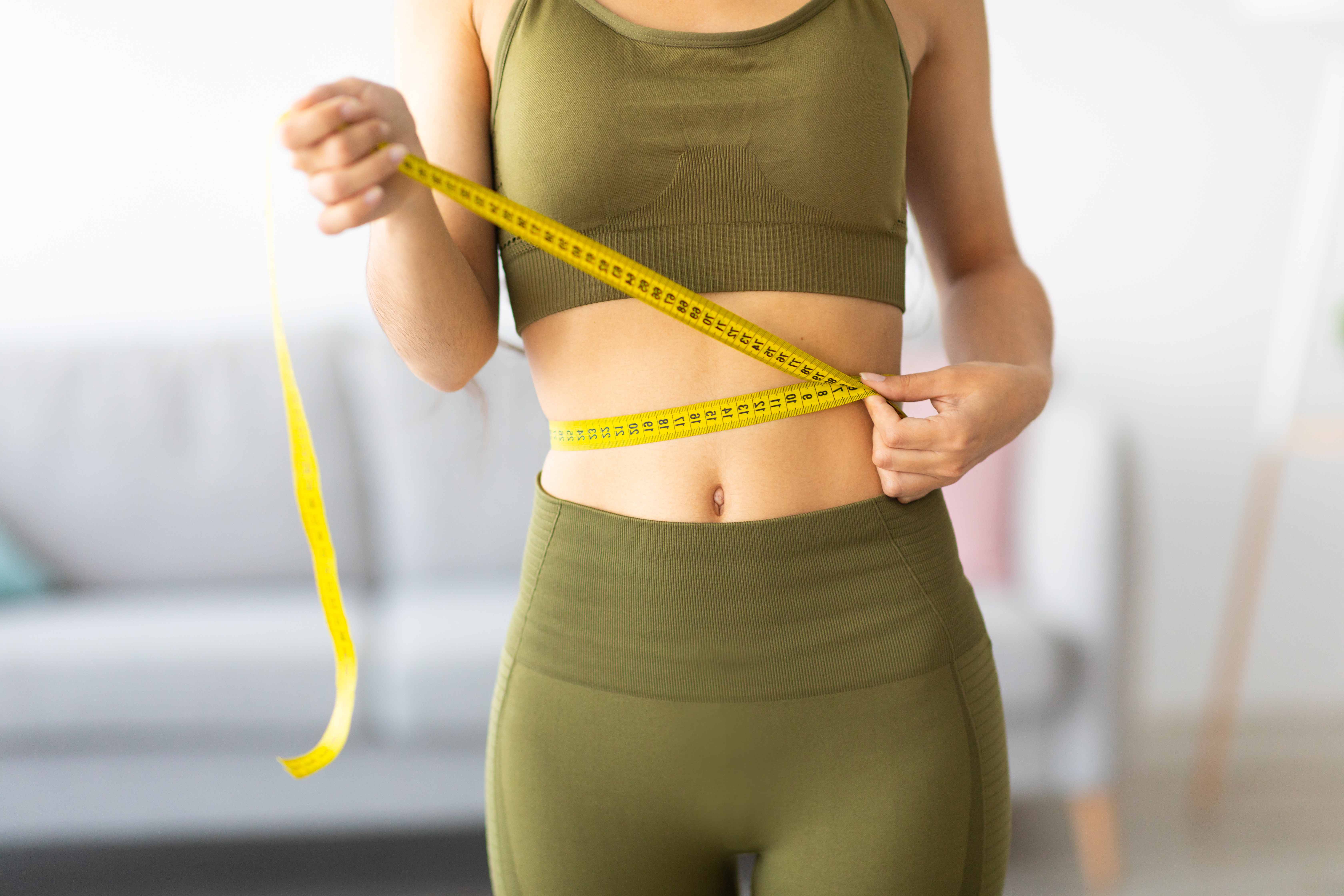 woman sizing her waist