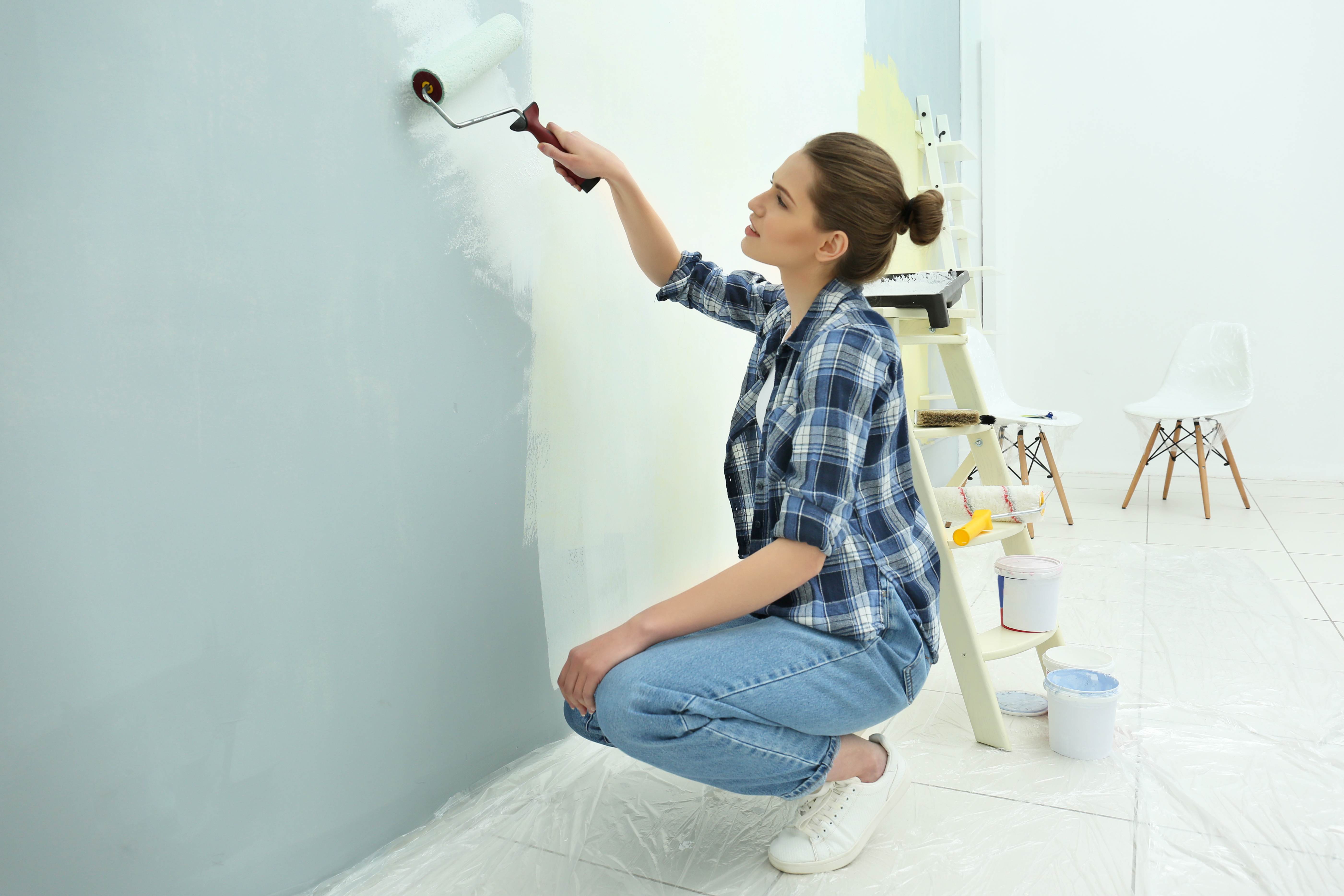 woman painting a wall