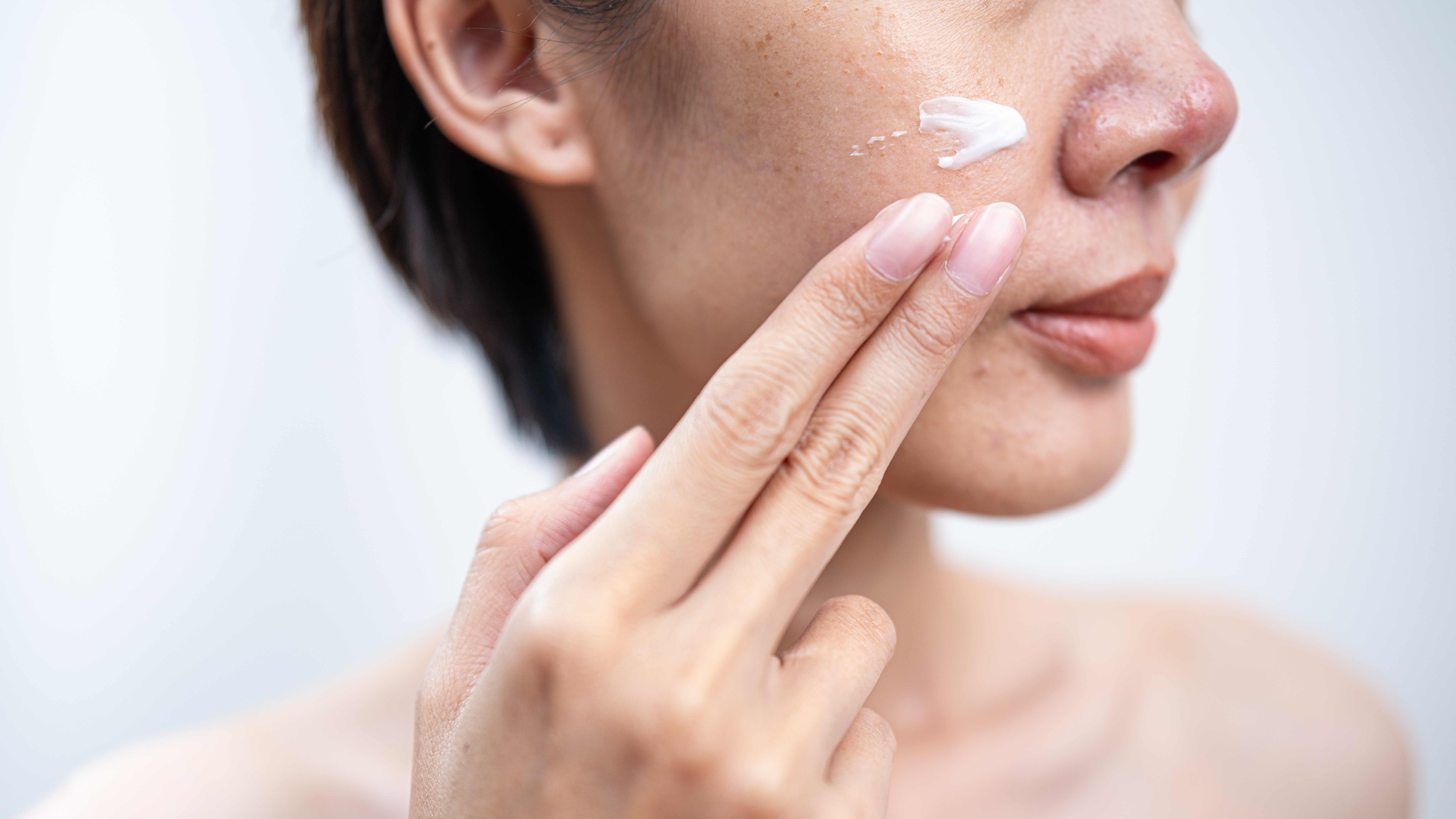 woman applying face cream